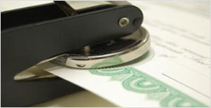 Close-up of hole punch on certificate